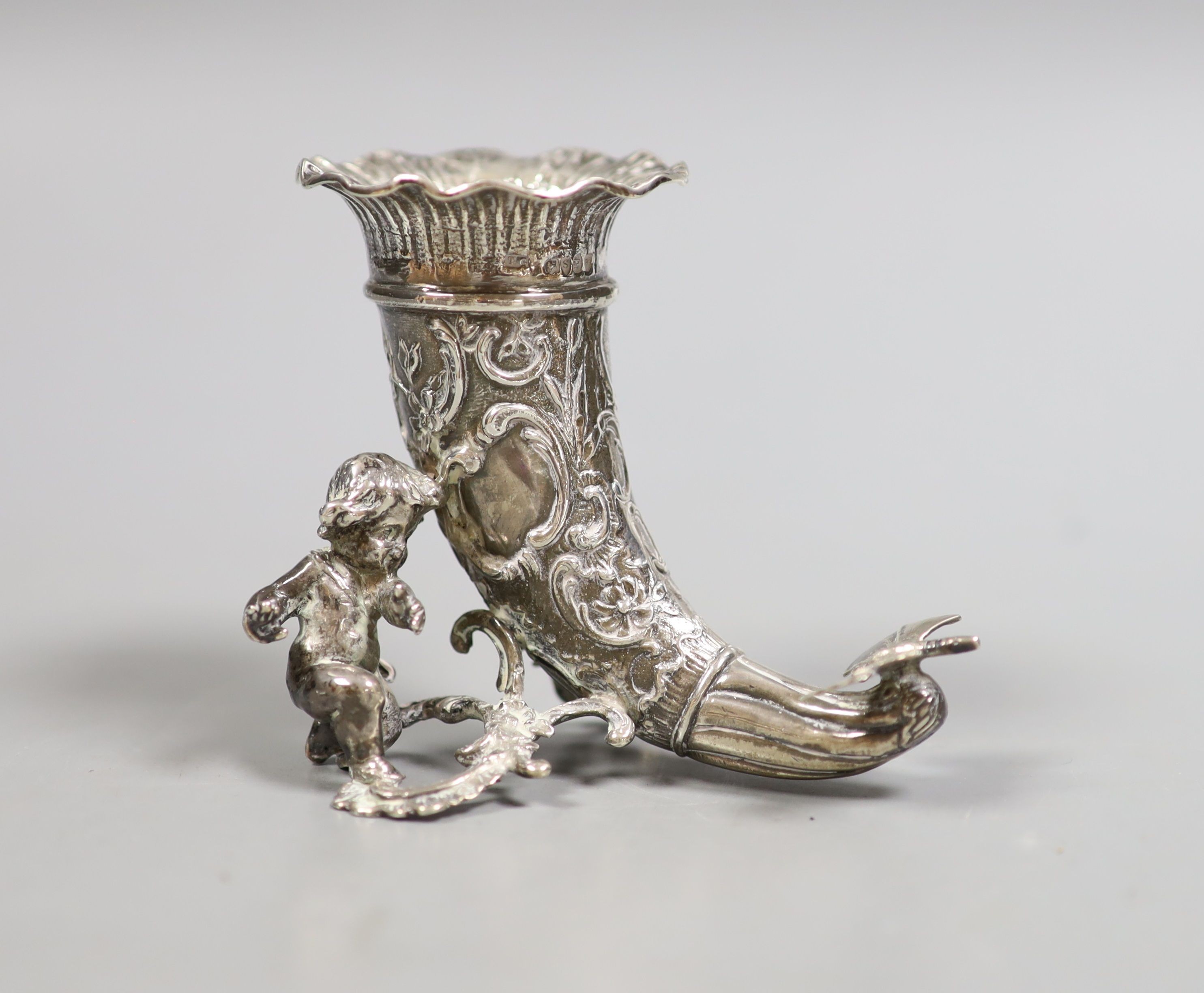 A late Victorian small silver cornucopia vase, with putto surmount, import marks for Thomas Glaser, London, 1893, height 75mm, 103 grams.